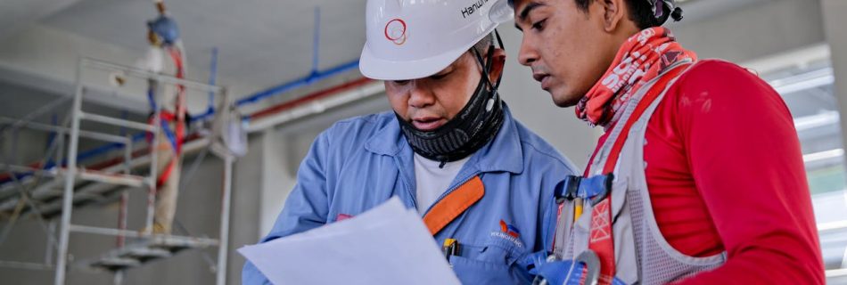 Two Man Holding White Paper